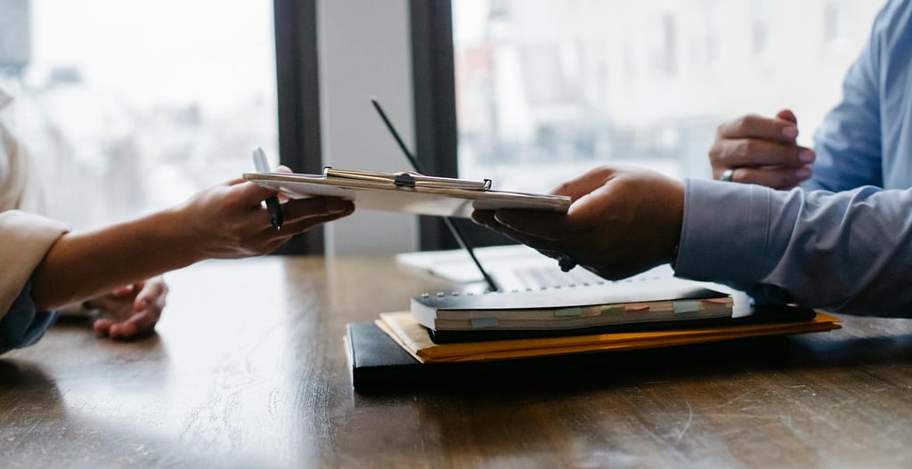 Two employees reviewing the benefits offered during an onboarding meeting.