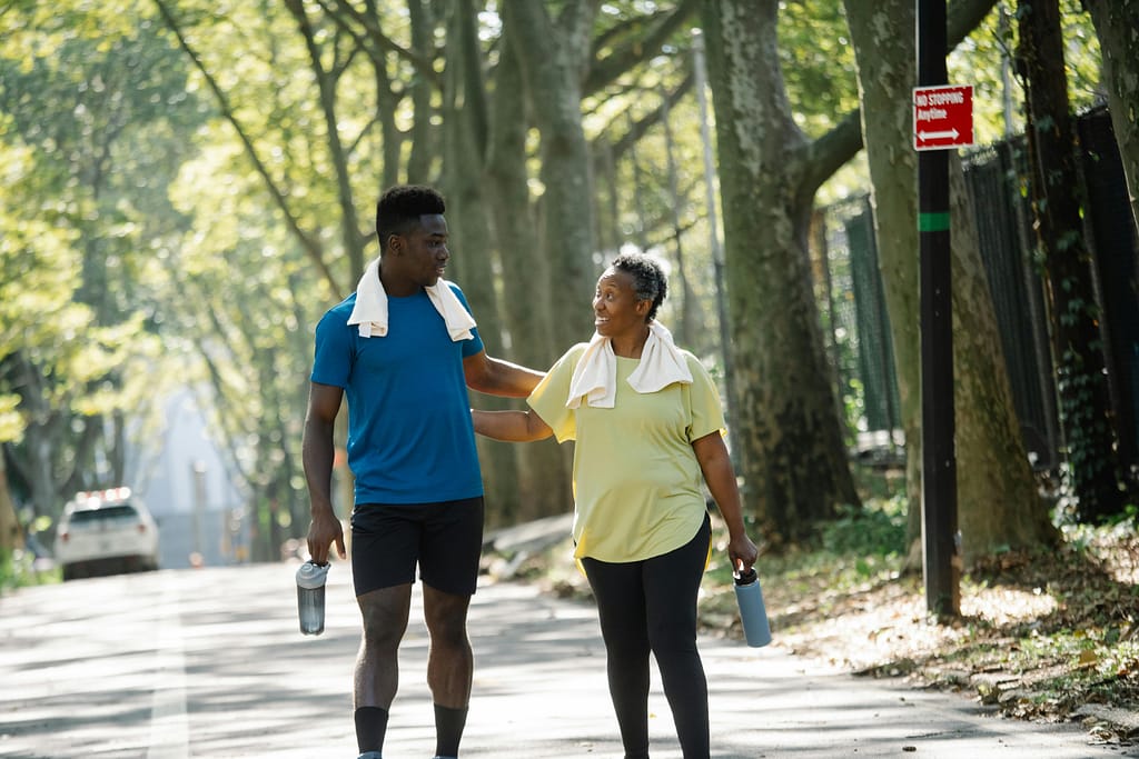 Multigenerational people on an exercise walk for employee wellness.