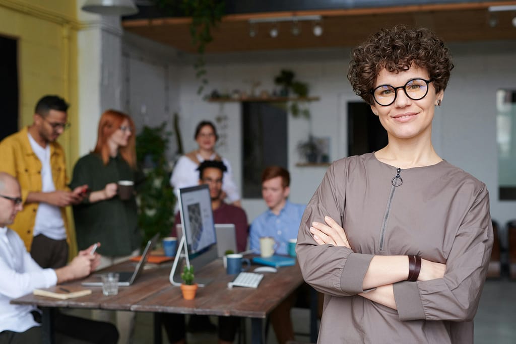 Female leader confidently assisting her team in a conference room.