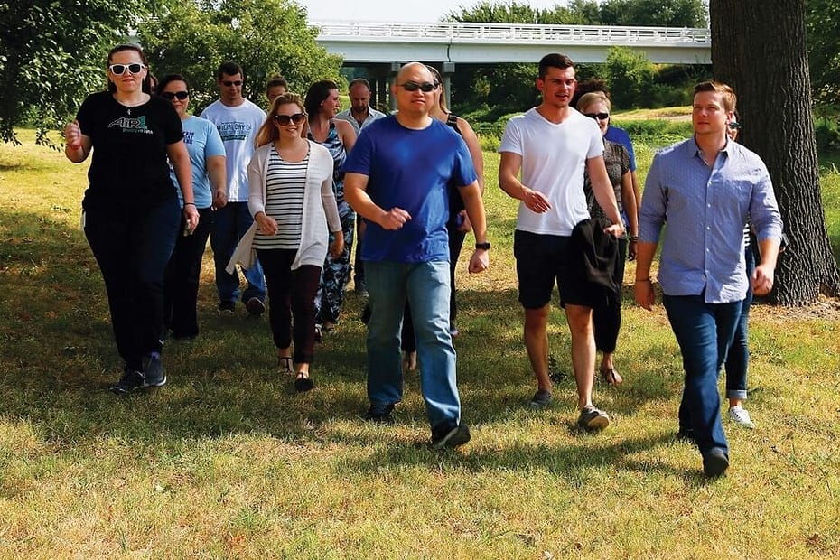 Workers taking a break from work to go on a group walk for exercise.