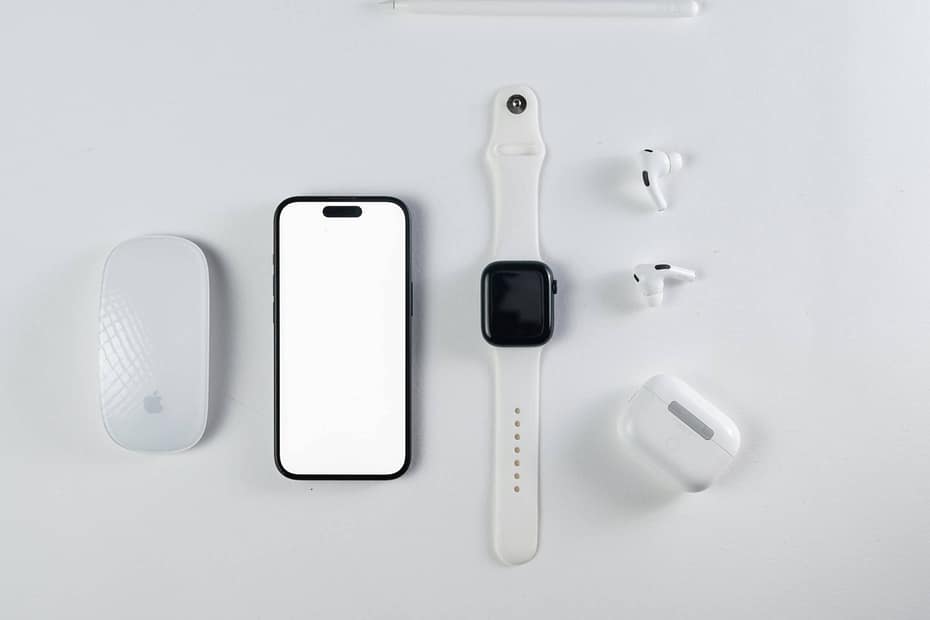 A picture of varies devices that can access wellness apps. A phone, watch, earbuds, digital writing pen, and computer mouse. Choosing the best employee wellness app is crucial for employee engagement and well-being. Learn what to look for in workplace wellness apps.