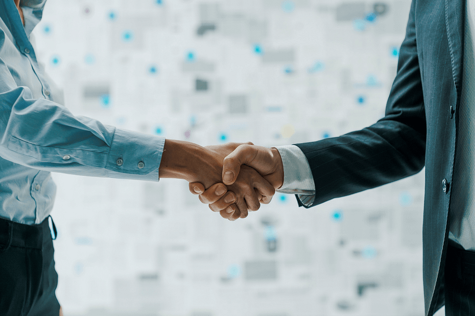 Employee benefits broker and employer representative shaking hands to establish a workplace wellness partnership with WellSteps.